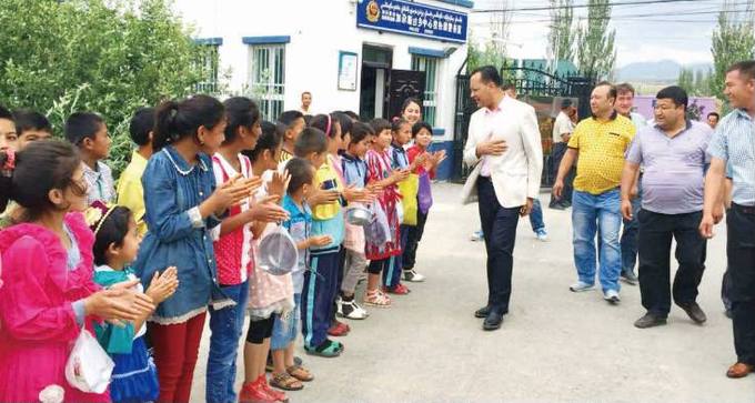 Children line the path to welcome the visit