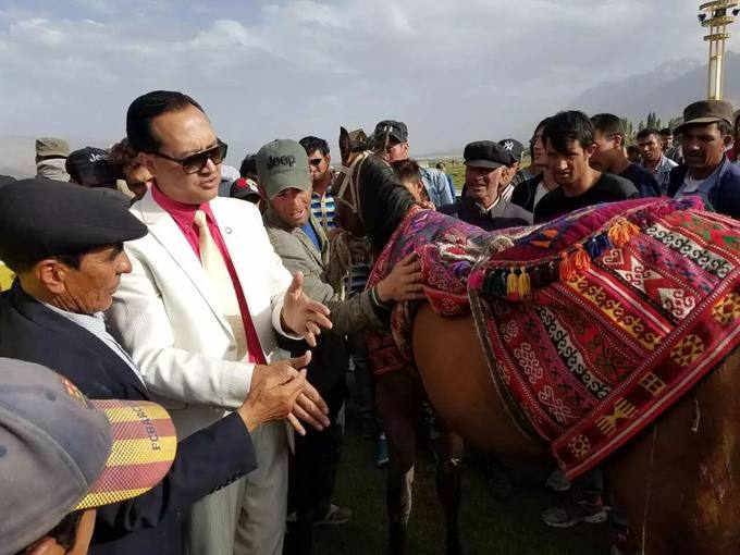 With a decorated horse at a festival on the plateau