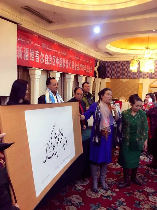 At a cultural evening with a calligraphic work