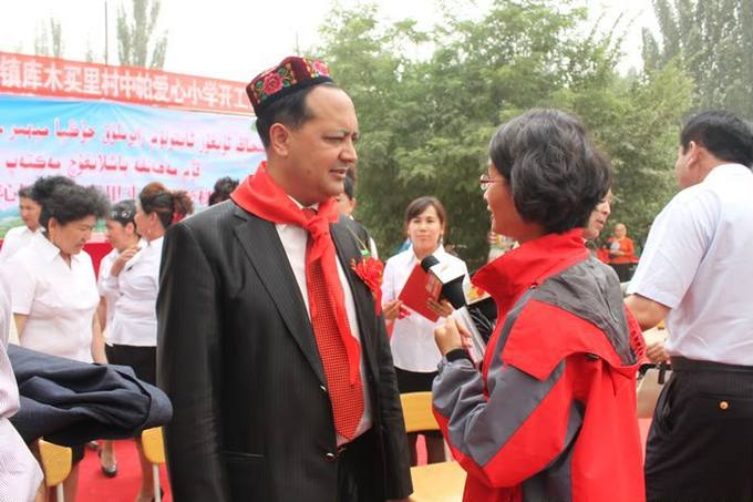 With schoolchildren in their red scarves