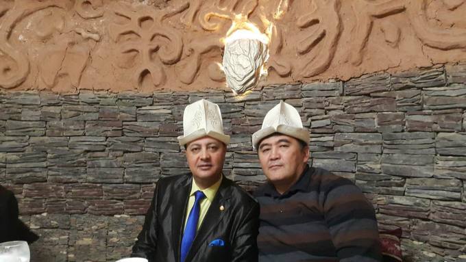 With a friend in Kyrgyz kalpak hats